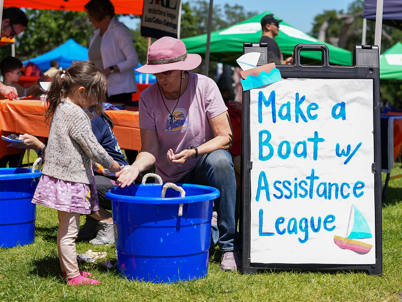 Assistance League volunteer helps child with STEM activity