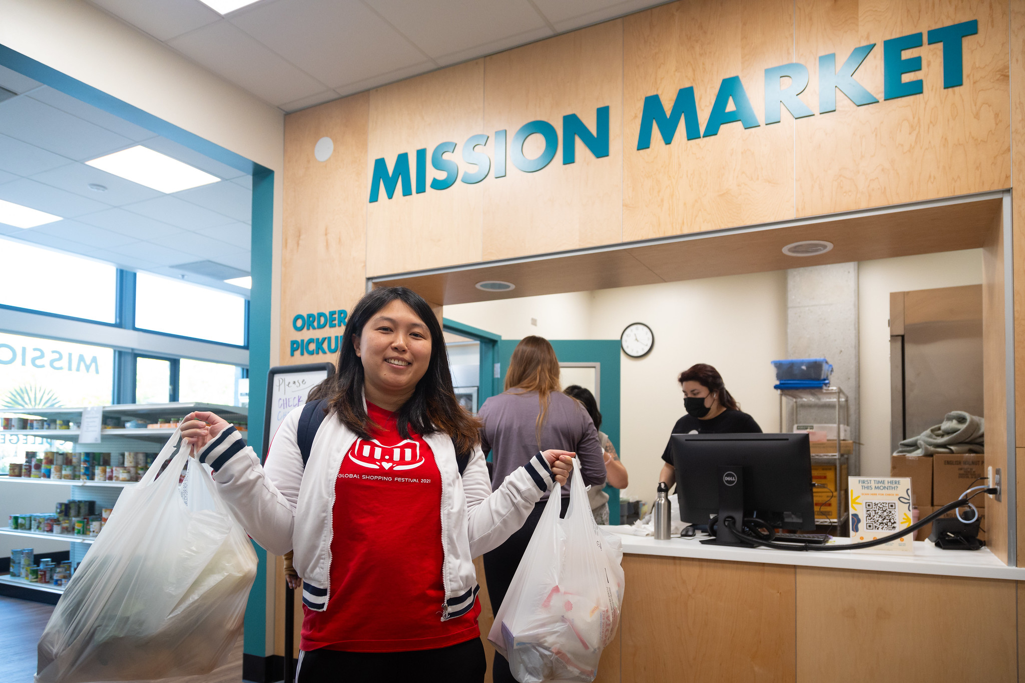 student gets free groceries from mission market